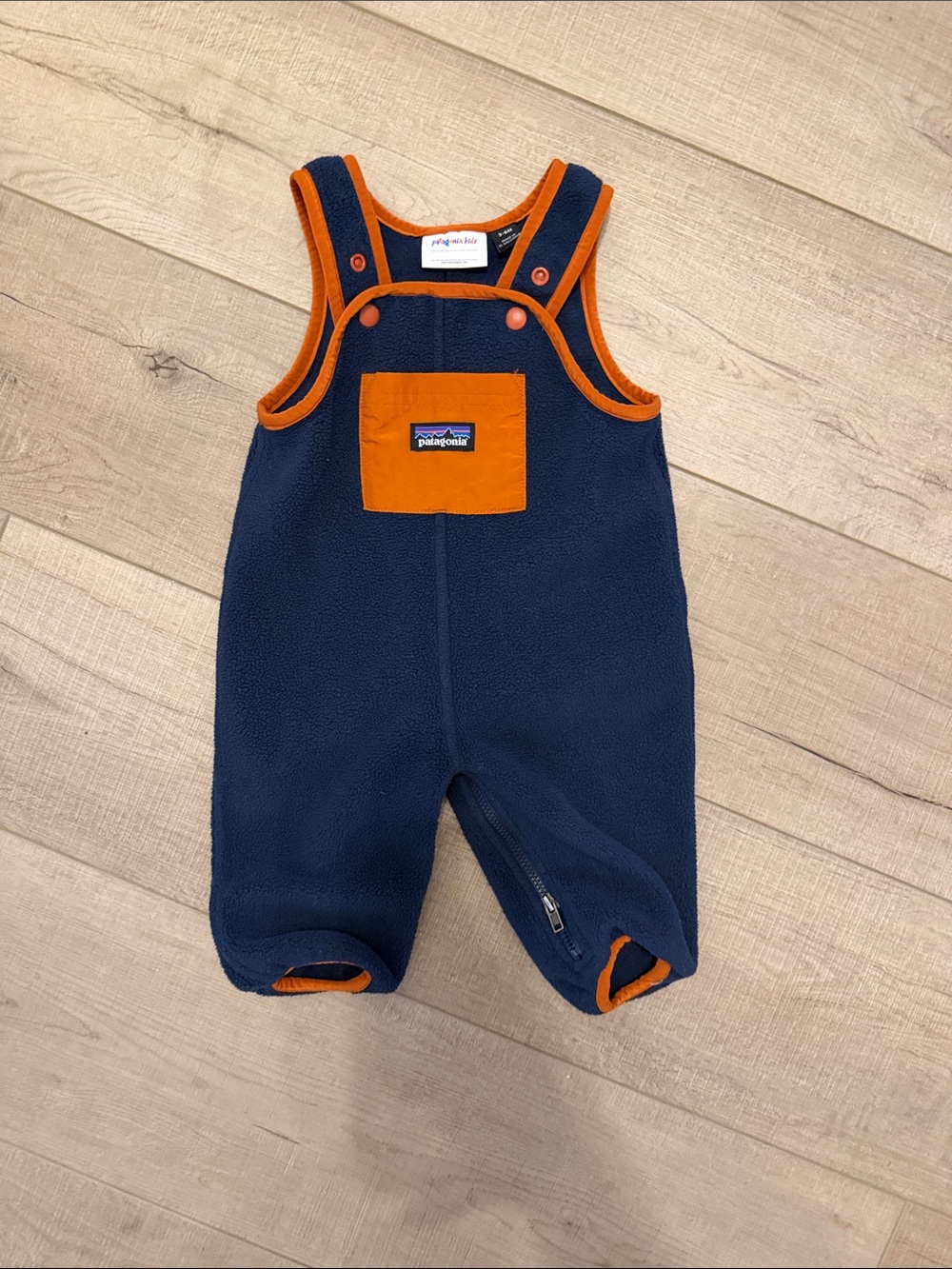 Patagonia navy fleece baby romper with orange trim